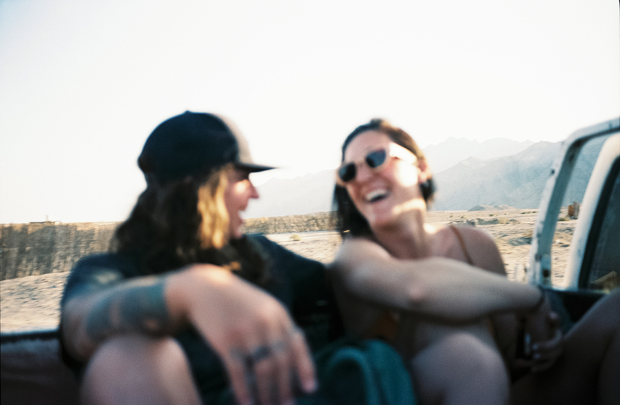 Two girls laughing in the back of a van in ras Abu Galoum, egypt