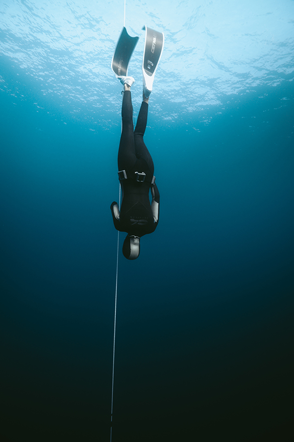 Freediver descending underwater in Dahab